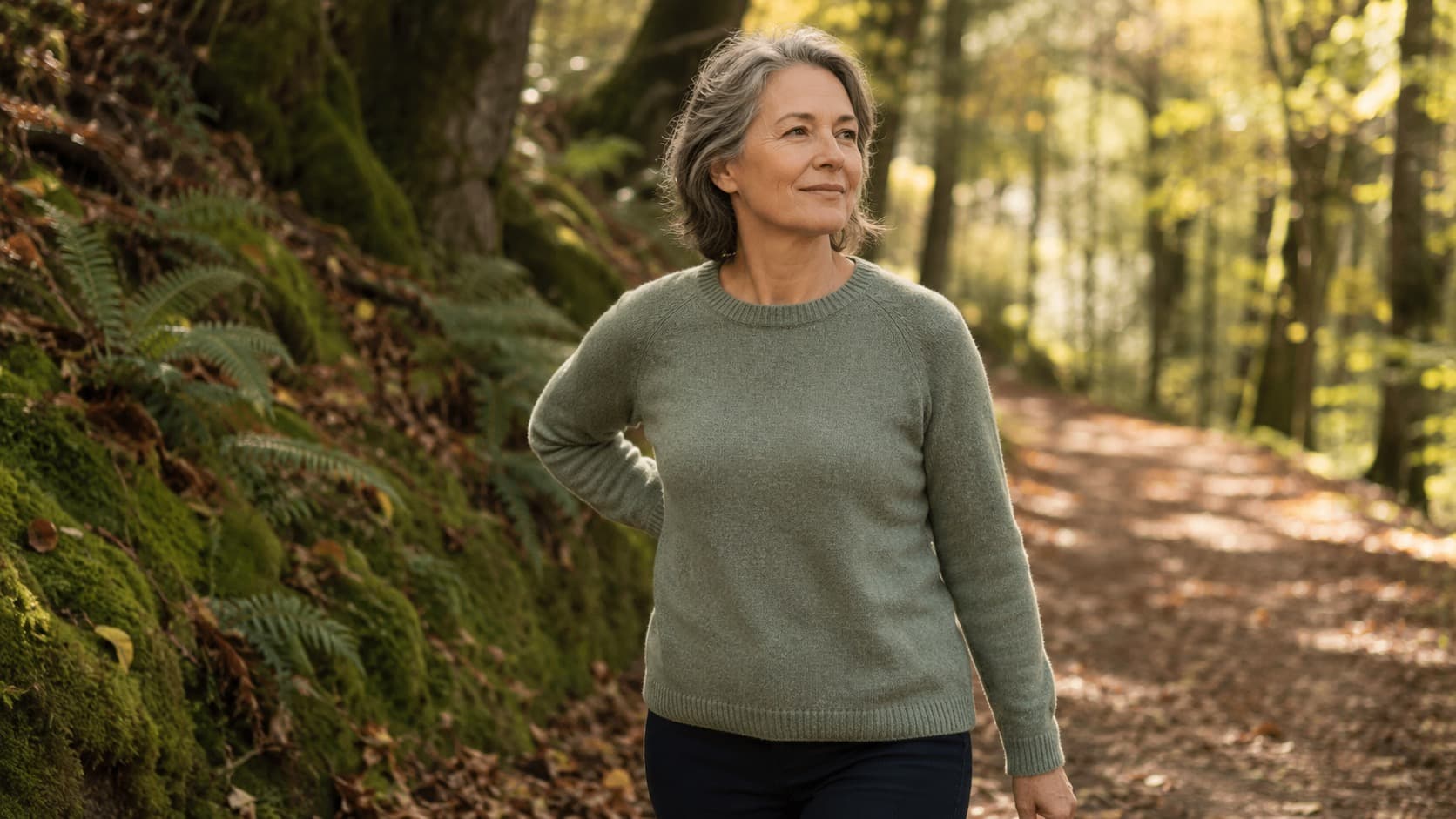 Woman walking peacefully along a green forest path in nature